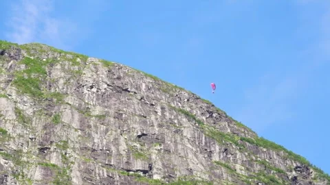 Paragliders soaring between the dramatic mountains of Norway Stock Footage 330259709