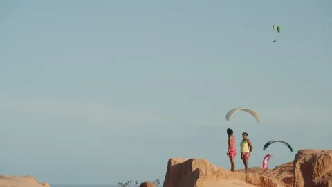 Paragliders Soaring over Red Sandstone Cliffs and Atlantic Ocean in Canoa Stock Footage 327424357