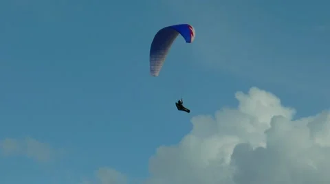 Paragliders soaring in the sky against a background of beautiful clouds. Stock Footage 68725657