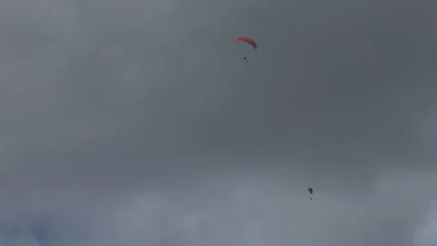 Paragliders soaring through cloud-covered skies with space for text Stock Footage 304800333