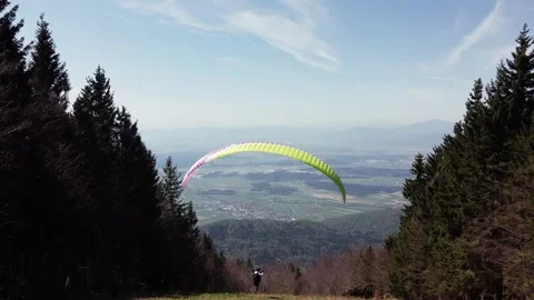 Paragliders take off on the thrill of gliding through the skies, capturing Stock Footage 273476432