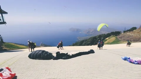 Paragliders takeoff in tandem with instructor Stock Footage 149733025