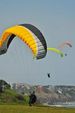 Paraglides flying Stock Photos