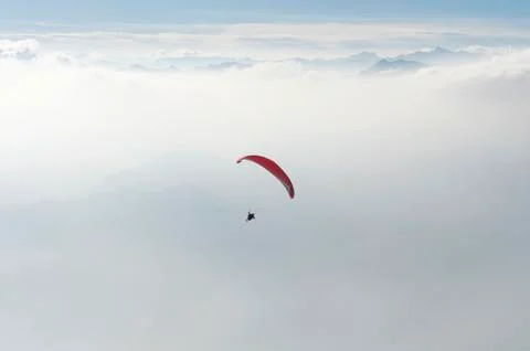 Paragliding above the clouds Stock Photos