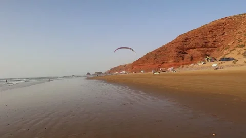 Paragliding against the backdrop of blue sky and red mountains Stock Footage 303429465