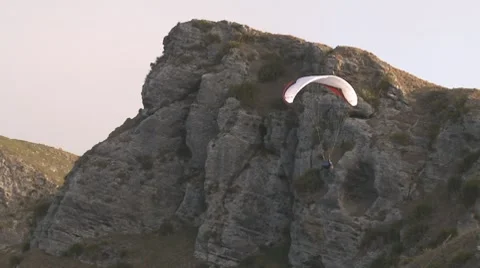 Paragliding along a cliff face Stock Footage 8691096