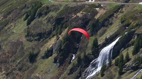Paragliding approaching a waterfall in the mountains 動画素材 219400981