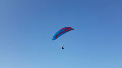 Paragliding on a blue sky background Stock Footage 137732600