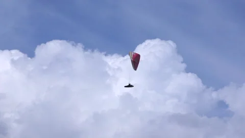 Paragliding in the blue sky next to the clouds Video stock 233682644
