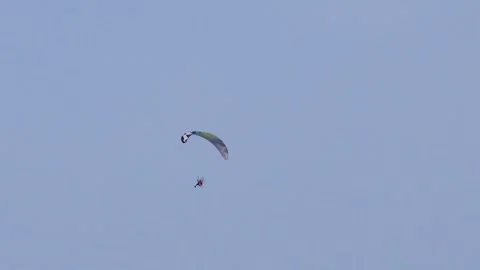 Paragliding in a cloudless sky Stock Footage 274318756