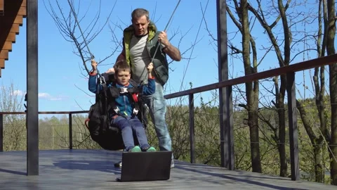 The paragliding coach teaches the boy. Stock Footage 154755576