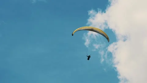 Paragliding Experience in Vast Clear Blue Sky, Ideal for Adventure Sports Stock Footage 306154374
