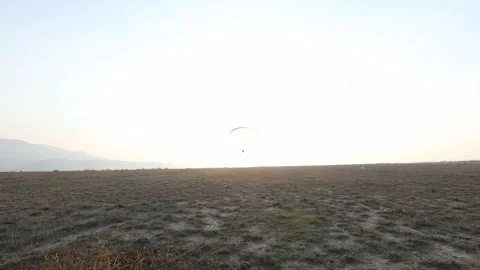 Paragliding in the field 2 Stock Footage 309554369