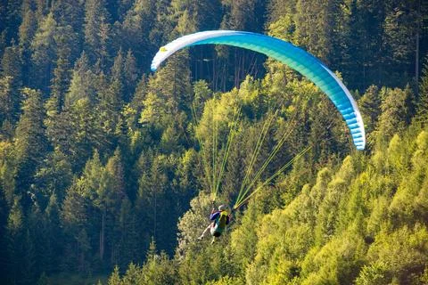 Paragliding flight in the austrian Stock Photos
