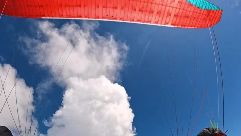 Paragliding flight in the clouds sky on red wing, adrenaline adventure freedom Stock Footage 276163522