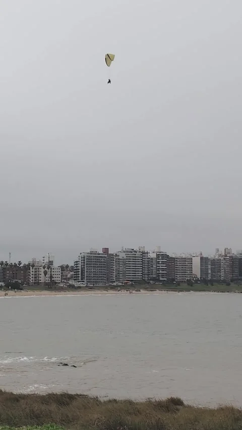 Paragliding flight in gray sky over Montevideo city, Uruguay Stock Footage 340159583