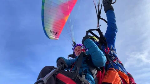Paragliding flight with an instructor over the Karakaol mountain ski base Video stock 232653344