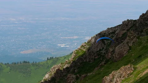 Paragliding flight in the mountains Stock Footage 303423999