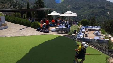 Paragliding instructor and client taking off and gliding into the distance. Video stock 244935550