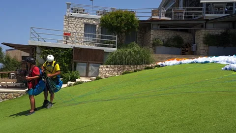 The paragliding instructor checking the equipment before taking off. Stock Footage 244935344
