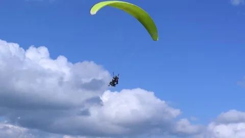 Paragliding. An instructor paraglider with passenger hover in sky during flight Stock Footage 258946394