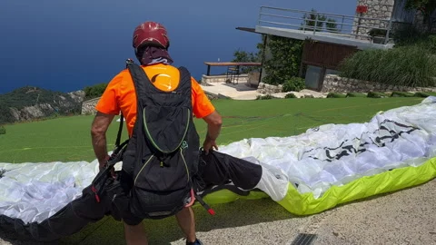The paragliding instructor preparing the parachute. Stock Footage 244935057