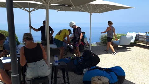 A paragliding instructor putting the equipment on a client Video stock 244932751