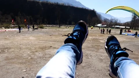 Paragliding landing at plan surface in valley from unique angle Stock-Footage 138802645
