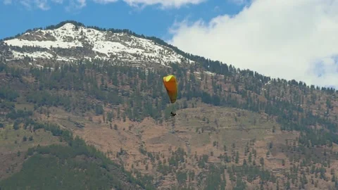 Paragliding with mountain view and bright sky at morning from different angle Stock Footage 244697564