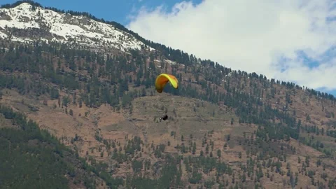 Paragliding with mountain view and bright sky at morning from different angle Stock Footage 244697588