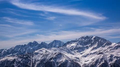 Paragliding over Alps with mountain cliffs covered with snow in Karnten Austria. Stock Photos