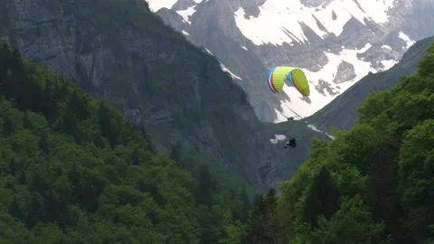 Paragliding over a forest in the mountains 動画素材 219400924