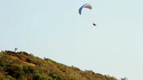 Paragliding over the mountains against clear blue sky Stock-Footage 32155910
