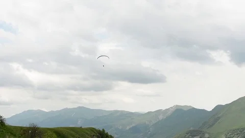 Paragliding over the mountains Stock-Footage 77243849