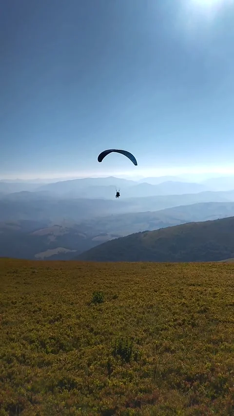Paragliding over the mountains Stock Footage 321056740