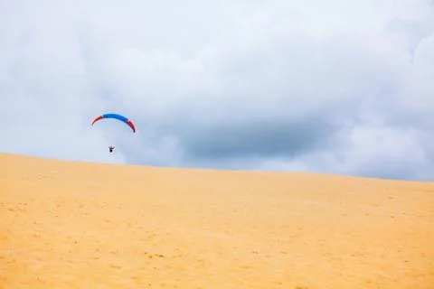 Paragliding over the sandy duna 写真素材
