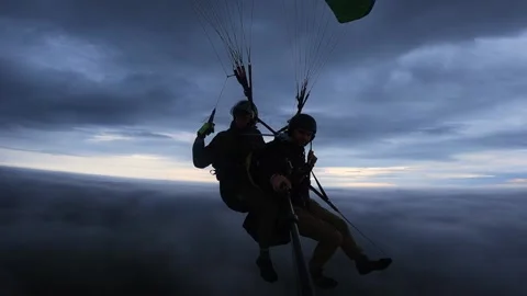 Paragliding in tandem above the clouds Video stock 221094781