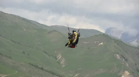 Paragliding tandem flying in front of the camera Stock Footage 63371505