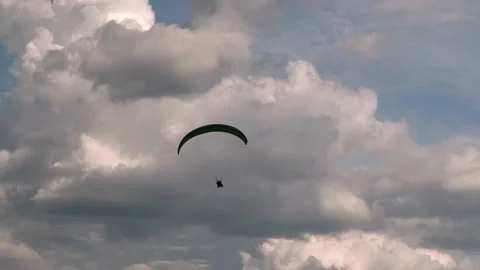 Paragliding in tandem over flat fields in cloudy weather Stock Footage 196034037