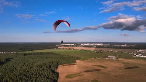 Paragliding in tandem over flat fields in sunny weather Stock Footage 196035084