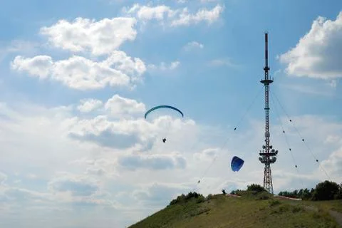 Paragliding at a telecommunication tower Stock Photos