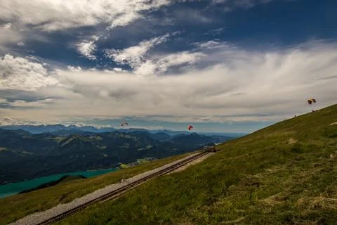 Paragliding on the top of the Schafberg with dramatic clouds int the background Stock Photos