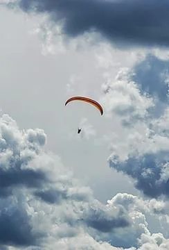 Paragliding under the clouds Stock Photos