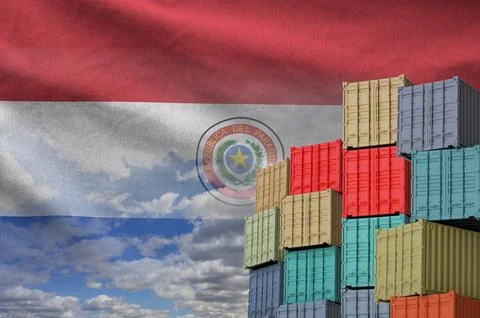 Paraguay flag and big stack of shipping cargo containers in docks with sky Foto stock
