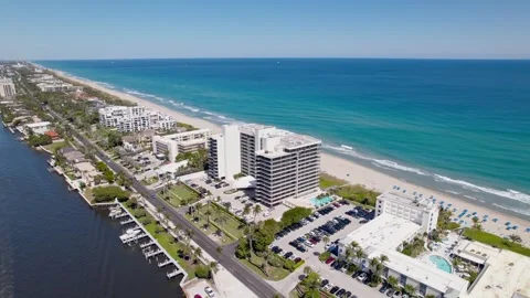 Parallax drone shot of beach next to Atlantic Ocean with hotels during the day Stock-Footage 304864576