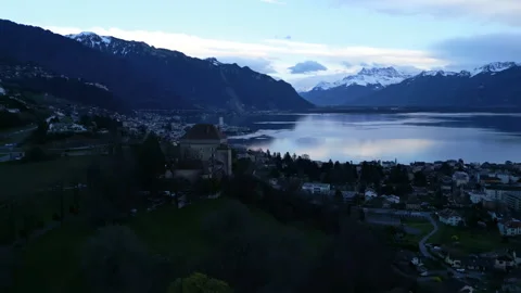 Parallax drone shot of Chatelard Castle, Dents du Midi and Lake Geneva at Stock Footage 306292183