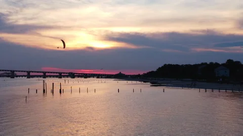 Parallax Drone Shot of Paramotor Flying during Golden Hour near Beach in Stock Footage 202265414