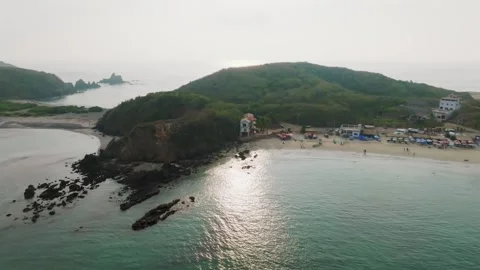 Parallax drone shot of Playa La Morita Tenacatita during the day with rocks and Vídeo Stock 306580595