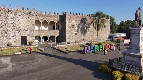 Parallax drone shot of the statue of Hernan Cortes in front of the Palace of Stock-Footage 303872193