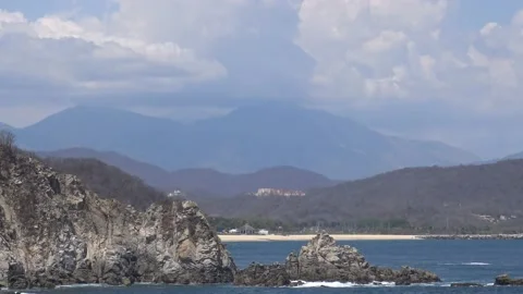 Parallax shot from left to right of cliffs revealing beach in background. Stock Footage 138677057